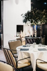 a table with chairs and a white table cloth at Hôtel Monsigny in Nice