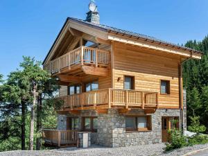 a large log house with a wrap around deck at Chalet Méribel, 7 pièces, 12 personnes - FR-1-565-1 in Les Allues