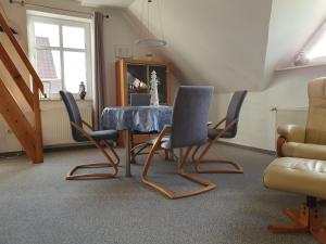 a dining room with a blue table and chairs at Ferienwohnung Zweite Heimat 45248 in Ditzum