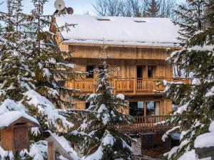 a log cabin in the winter with snow on the roof at Chalet Méribel, 5 pièces, 11 personnes - FR-1-565-46 in Les Allues