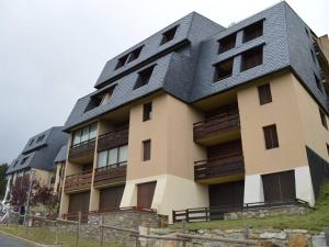 a building with a black roof on top of it at Studio Les Angles, 2 pièces, 5 personnes - FR-1-593-83 in Les Angles