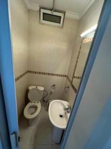 a bathroom with a toilet and a sink at Apartment in Shmaisani in Amman