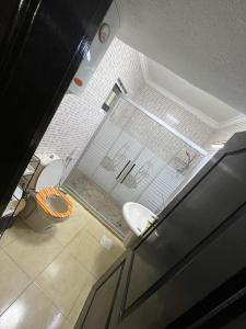 a bathroom with a toilet and a glass window at Apartment in Shmaisani in Amman