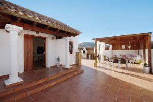 a patio of a house with a table and chairs at Villa Baobab in Corralejo