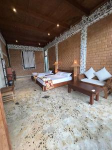 a large room with two beds and a table at OHEI in Tangalle