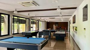 a pool table in a room with three sinks at Life At REPOSE- Lake Villas Resort & Club in Chor Warodra