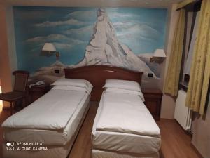 Cama ou camas em um quarto em Hotel Breuil