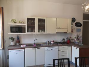 サレルノにあるCasa di Lindaの白いキャビネットとシンク付きのキッチン
