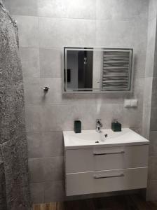 Noclegi Budomas Klima-ParkigFree-SmartTv في فروتسواف: حمام مع حوض أبيض ومرآة