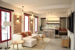 a living room with a white couch and a fireplace at Leiden Homestay&Cafe' in Ho Chi Minh City