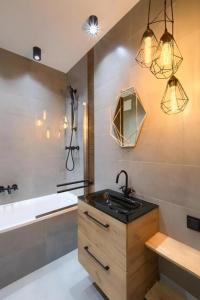 a bathroom with a sink and a bath tub at Platinum Towers Apartments in Warsaw +37 photos