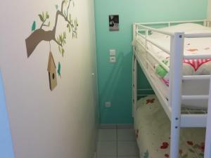a small bedroom with a bunk bed with a ladder at Appartement Fort-Mahon-Plage, 2 pièces, 4 personnes - FR-1-482-15 in Fort-Mahon-Plage