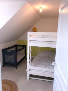 a bedroom with two bunk beds in a attic at Maison de pêcheur+ jardin 5 min à pieds de la Baie in Le Crotoy