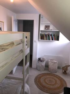 a bedroom with a bunk bed and a book shelf at Maison de pêcheur+ jardin 5 min à pieds de la Baie in Le Crotoy