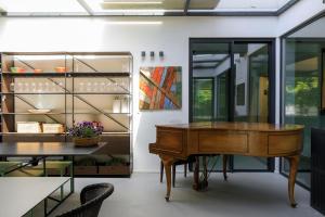 a dining room with a table and a piano at Domìa Boutique Hotel e Cucina in Mondello