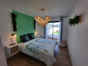 a bedroom with a bed and a green wall at Domaine de Pacciolello - Porticcio in Porticcio