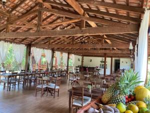 a dining room with tables and chairs and fruit at Amazônia ParkSuítes in Novo Airão