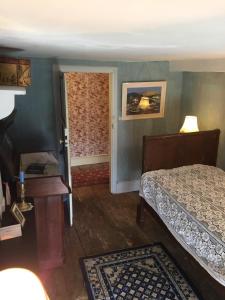 a bedroom with a bed and a table and a door at Château de Couin in Couin