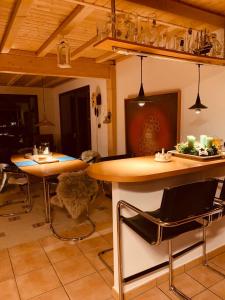 a kitchen with two tables and chairs in a room at Unique Sustainabel Lodge in the Swiss Jura Mountains in Neuchâtel