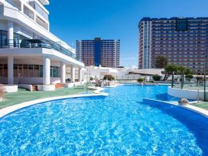 a large swimming pool in front of a building at 1316 Ocean View Studio Paraiso in Playa Paraiso