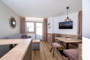 a living room with a table and a dining room at Apartments Dorfbäck in Stumm