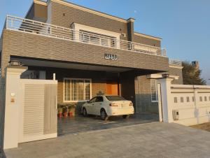 a car parked in the garage of a house at Islamabad Travelodge Guest House in Rawalpindi