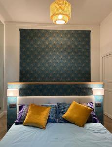 a bedroom with a large bed with two yellow pillows at Isola suites in Milan