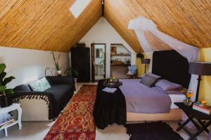 a bedroom with a bed and a couch at Southern Yurts in Botrivier