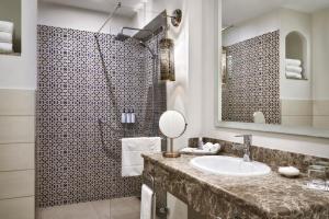 a bathroom with a sink and a shower at The Cove Rotana Resort - Ras Al Khaimah in Ras al Khaimah