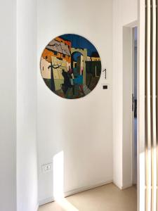 a painting on a wall in a room with a hallway at Domìa Boutique Hotel e Cucina in Mondello