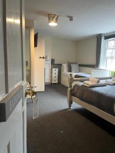 a bedroom with two beds and a window at The White Hart in Newenden