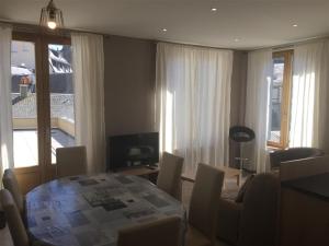 a living room with a table and chairs and a room with a window at Appartement Mont-Dore, 3 pièces, 6 personnes - FR-1-415-67 in Le Mont-Dore