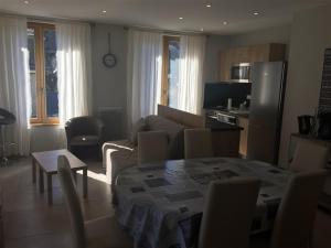 a kitchen and living room with a table and a couch at Appartement Mont-Dore, 3 pièces, 6 personnes - FR-1-415-67 in Le Mont-Dore
