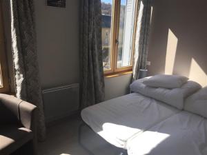 a bedroom with two beds and a window at Appartement Mont-Dore, 3 pièces, 6 personnes - FR-1-415-67 in Le Mont-Dore