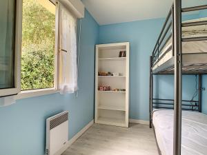 a bedroom with a bunk bed and a window at Maison Crozon, 3 pièces, 4 personnes - FR-1-370-42 in Crozon