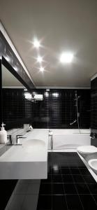 a bathroom with two sinks and a bath tub at voco Nola - Naples Vulcano Buono by IHG in Nola