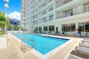 a swimming pool in front of a building at Deluxe 1 BR suite with Pool, Parking, Balcony and Ocean Views in Miami
