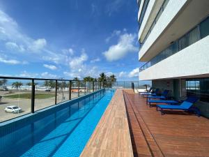a swimming pool on the balcony of a building at Residencial SAN MARINO BEIRA MAR in Ilhéus