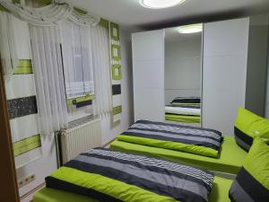 a bedroom with two beds and a mirror at Haus Nutheblick - Komfort Appartement in Trebbin