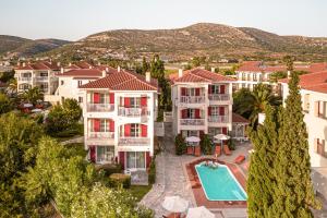 an apartment complex with a swimming pool and a resort at Hydrele Beach Hotel & Village in Potokáki