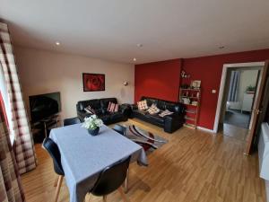 a living room with a table and a couch at Granite Getaways - Union Skyview in Aberdeen