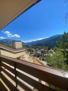 a view of a city from a balcony at Encia's Home Dolomiti in Castello di Fiemme
