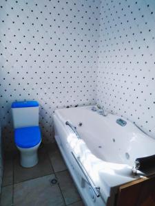 a bathroom with a white tub and a toilet at City Stay lodging center in Botianaw