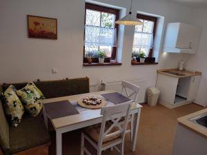 a kitchen and living room with a table and a table and chairs at Apartmán FuFu in Prostřední Lánov