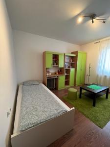 a bedroom with a bed and a table in it at Apartman Nikola in Belgrade