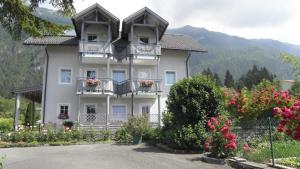 a large white building with balconies and flowers at Appartment Isabelle Sky in Presseggersee