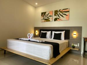 - une chambre avec un grand lit avec un lapin dans l'établissement IBI bali, à Banjar