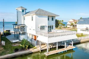 a house on the water with a dock at Chiquita Bonita in Galveston