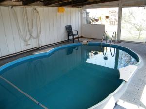 a large swimming pool in a house with a patio at Ferienbungalow Meerjungfrau im Seebad Ueckermünde in Ueckermünde