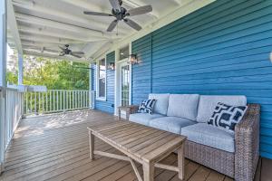 a blue house with a couch and a table on a porch at The Darcy in Hot Springs